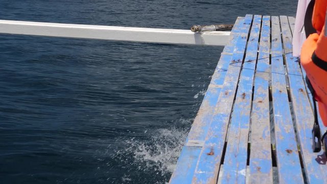Water Splashing From The Left Side Of An Island Hopping Tour Boat In Blue Ocean. Slow Motion.