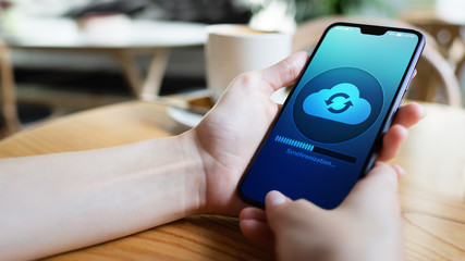 Mobile phone cloud synchronisation process on device screen. Technology concept.