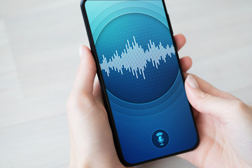 Voice recognition application on smartphone screen. Artificial intelligence and deep learning...