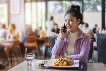 woman talking on mobile phone in restaurant