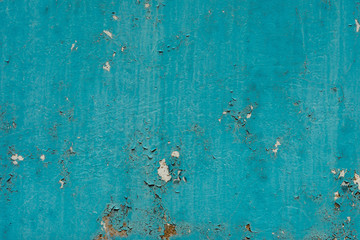 Fototapeta na wymiar light coloured blue peeling paint on the old rough concrete surface