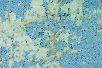 light coloured blue peeling paint on the old rough concrete surface