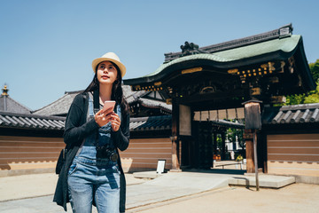 tourist holding mobile phone standing outdoor