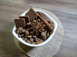 Aromatic coffee in beans and spices and chocolate
