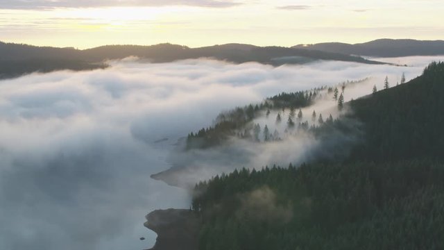Aerial view of forests lakes and mountains covered in mist of Oregon county