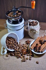 Aromatic coffee beans in a mug and mill and spices