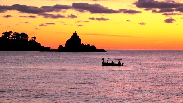 Fishermen on the sea. Fishermens drive the boat and go to the fishing at sunset. The island of St. Sunday and Katic, Petrovac na moru, Montenegro