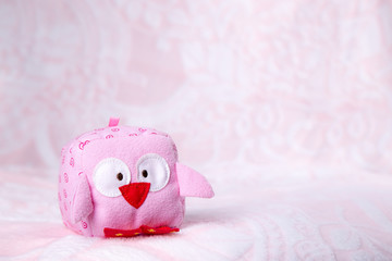 Toy owl on a pink background
