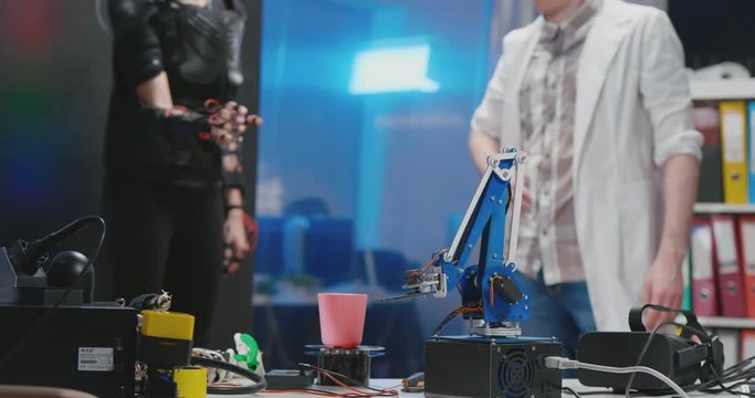Scientists carrying out experiment with robot control suit