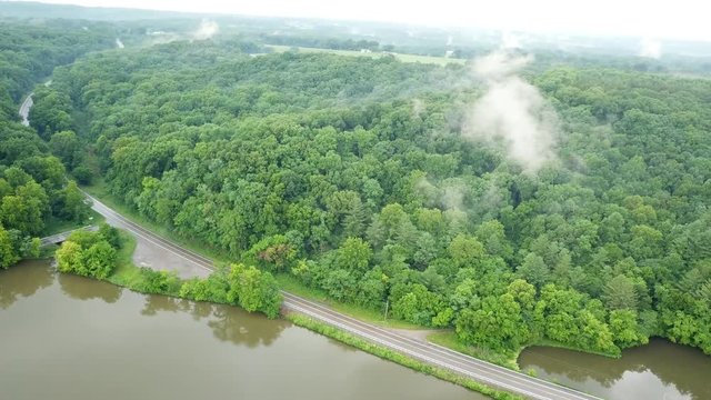 Rotating shot around a low cloud in the mountains