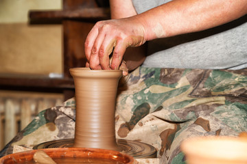 Hands of Potter man sculpt something by clay in a craft workshop