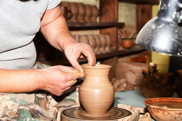 Hands of Potter man sculpt something by clay in a craft workshop