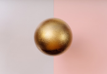 Golden Christmas ball pattern on pink and grey background