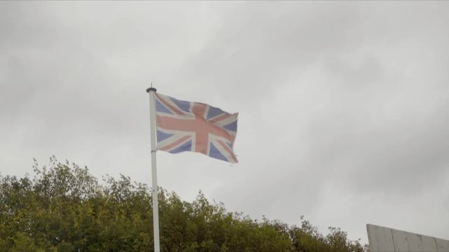 Union Jack flag of the United Kingdom of Great Brittain or UK flag waving in the wind | 4K - VINTAGE STYLE WITH PROJECTOR