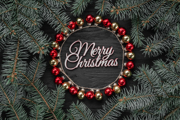 Christmas ball circle on a dark wooden background. Christmas style, round frame. Top view, place for text, flat lay. Xmas and happy new year greeting card.