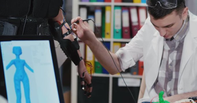software engineer work on robot hand for woman to digital transformation bionic arm.