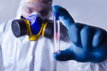 Lab worker holding a test tube.