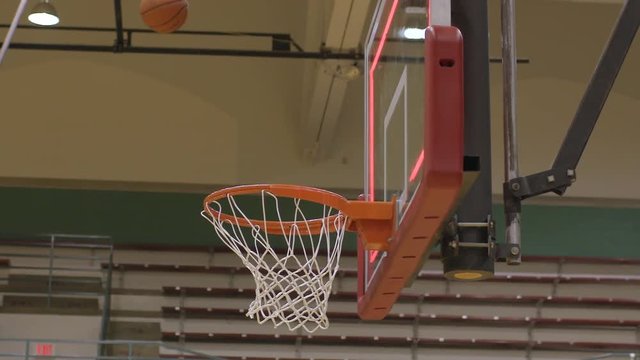 Closeup low angle of a basketball making a basket for three points