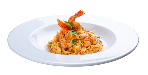 Pasta with salmon and shrimp. On a white background.