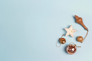 Golden Christmas decorations with copy space on blue background.