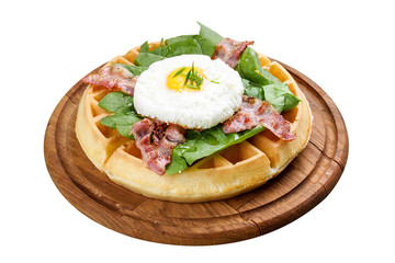 Round American waffle on a white background. Stuffed with egg, bacon and spinach.