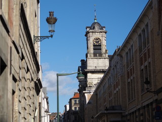 Obraz premium Clock tower of Saint John and Saint Stephen Church from across the road in Brussels, Belgium