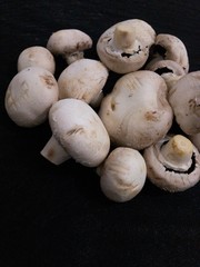 Creative Top view flat lay of fresh raw mushrooms on black background with copy space