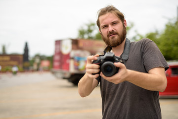 Young bearded tourist man having vacation in Ayutthaya, Thailand