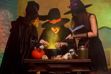 Picture of three witches boiling potions in cauldron