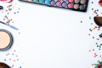 Picture on top of eye shadows, brushes, , tangerine, sugar cane on empty white table