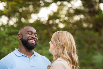 Fototapeta premium Loving mixed race couple hugging and laughing.