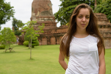 Naklejka premium Young beautiful tourist woman having vacation in Ayutthaya, Thai
