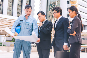 business manager and engineer meeting project at construction site