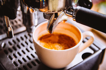 Soft focus. Close-up .Espresso pouring from making fresh coffee machine,Professional coffee shop...