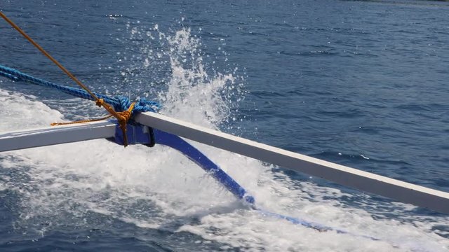 Water Crashing On The Side Of A Moving Paraw Bamboo Tour Boat In The Philippines. View From The Boat. Slow Motion.