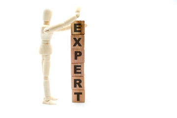 Wooden figure as businessman building Expert concept as tower of wood cubes