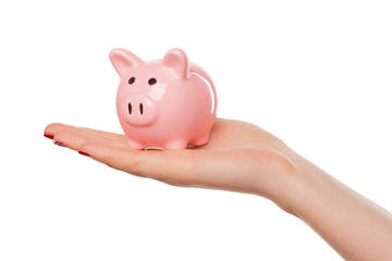 Woman holding a pink piggy bank isolated on white