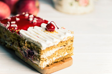 delicious cherry sponge cake with white cream and red jelly