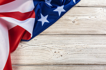 Fototapeta na wymiar USA flag on light wooden table background close up copy space