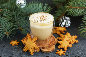 Gingerbread snowflake cookie, a cup of cappuccino for christmas.