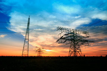 In the evening, the silhouette of high voltage towers