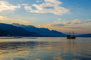 Montenegro, Kotorsky gulf, Adriatic Sea. Dawn, ship, mountains.