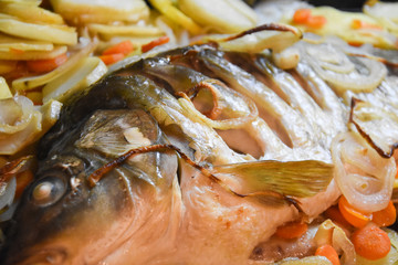 Carp baked in pots with potatoes and onions. Baked fish