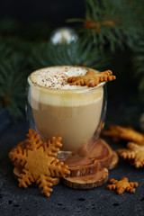 Gingerbread snowflake cookie, a cup of cappuccino for christmas.