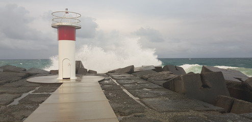 lighthouse and crashing waves