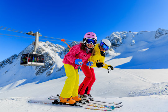 Happy family enjoying winter vacations in mountains . Ski, Sun, Snow and fun.
