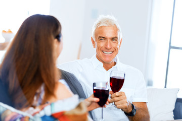 Portrait of a couple having a glass of red wine