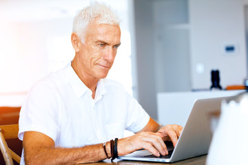Fototapeta premium Man working on laptop at home