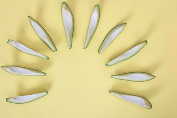 Obraz premium Avocado slices isolated on yellow background