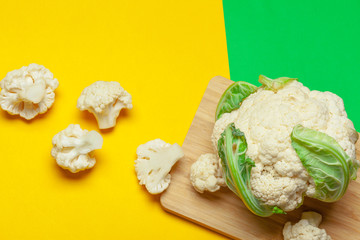 Cauliflower pieces on a bright yellow background